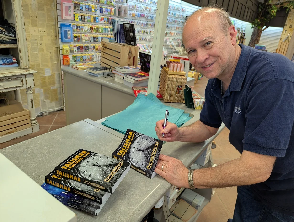 Tom Catalano signing books at a shop counter